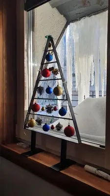 a christmas tree in a window in a room at Apartman Gvozdac, Župa - Kopaonik in Kopaonik