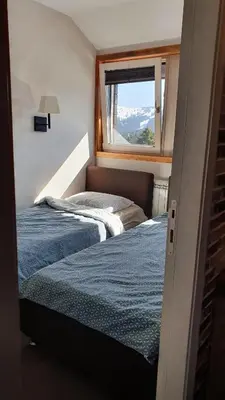 a bedroom with two beds and a window at Apartman Gvozdac, Župa - Kopaonik in Kopaonik