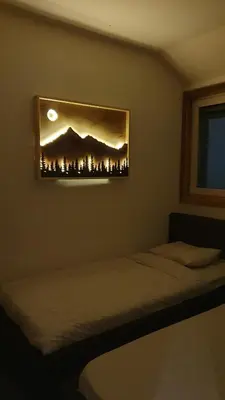 a bedroom with two beds and a picture on the wall at Apartman Gvozdac, Župa - Kopaonik in Kopaonik