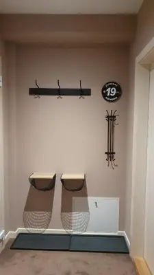 a room with two chairs and a clock on the wall at Apartman Gvozdac, Župa - Kopaonik in Kopaonik