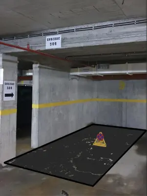 a parking garage with a pizza sign on a floor at Apartman Gvozdac, Župa - Kopaonik in Kopaonik
