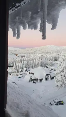 a view from a window of a village covered in snow at Apartman Gvozdac, Župa - Kopaonik in Kopaonik