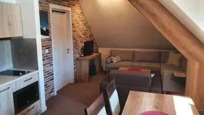 a living room with a couch and a table at Apartman Gvozdac, Župa - Kopaonik in Kopaonik