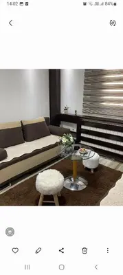 a living room with a couch and a table at ANASTASIJAKOP in Kopaonik