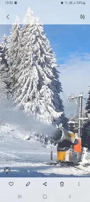 a snow covered mountain with a train in front of it at ANASTASIJAKOP in Kopaonik