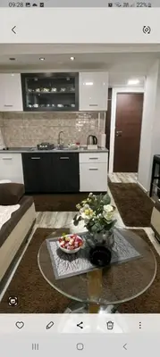 a living room with a table with a bowl of flowers at ANASTASIJAKOP in Kopaonik