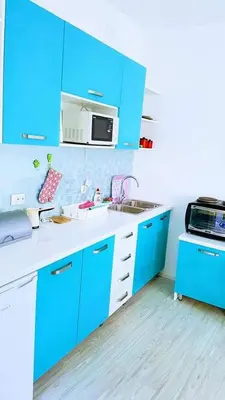 a blue kitchen with a sink and a microwave at Apartman Ivanovic 6 Sokobanja in Soko Banja
