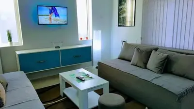 a living room with a couch and a table at Apartman Ivanovic 6 Sokobanja in Soko Banja
