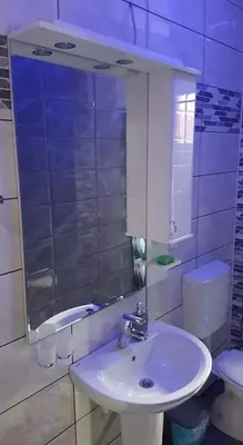 a bathroom with a sink and a toilet and a mirror at Apartman Ivanovic 6 Sokobanja in Soko Banja