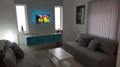 a living room with a couch and a table at Apartman Ivanovic 6 Sokobanja in Soko Banja