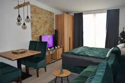 a bedroom with a bed and a table and a couch at Eagle View Milmari N81 in Kopaonik