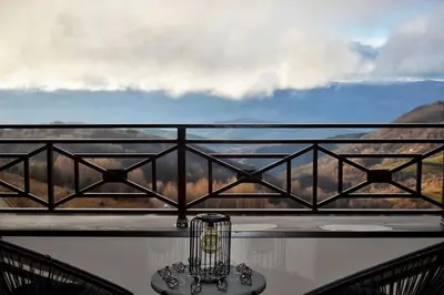 a lantern on a balcony with a view of the mountains at Eagle View Milmari N81 in Kopaonik