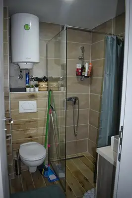 a bathroom with a shower with a toilet and a shower curtain at Eagle View Milmari N81 in Kopaonik