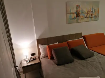 a bedroom with a bed with two pillows on it at Milmari Future Gold Apartmani Kopaonik in Kopaonik