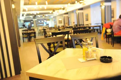 a dining room with a table and chairs and a table and chairsktop at Milmari Future Gold Apartmani Kopaonik in Kopaonik