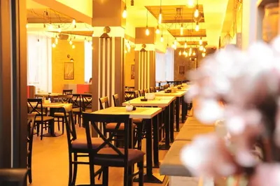 a row of tables and chairs in a restaurant at Milmari Future Gold Apartmani Kopaonik in Kopaonik