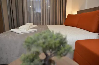 a hotel room with a bed with towels on it at Milmari Future Gold Apartmani Kopaonik in Kopaonik