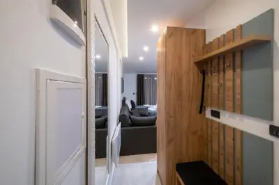 a hallway leading to a living room with a couch at Milmari - Apartman N85 in Kopaonik