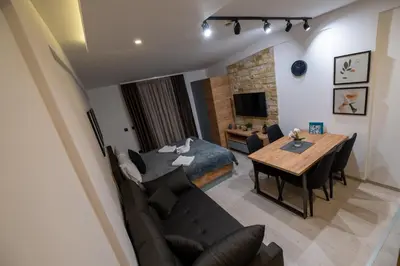 a living room with a table and a dining room at Milmari - Apartman N85 in Kopaonik
