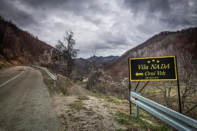 a yellow sign on the side of a road at Vila Nada in Crni Vrh