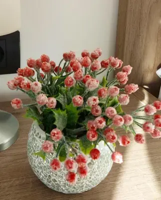 a vase filled with pink flowers on a table at Ivkovic spa Milmari N16 in Kopaonik