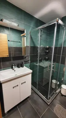 a bathroom with a glass shower and a sink at Relax apartment Kopaonik in Kopaonik