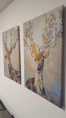 two paintings of a deer on a wall at Relax apartment Kopaonik in Kopaonik