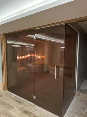 a glass door in a room with a fireplace at Kopaonik apartmani NR in Kopaonik
