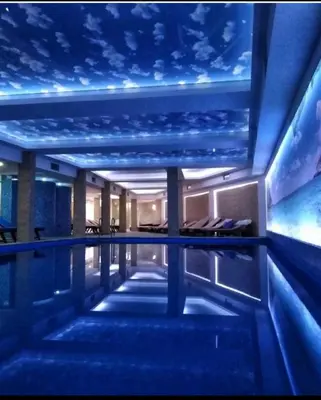 a swimming pool in a hotel with a star ceiling at Kopaonik apartmani NR in Kopaonik