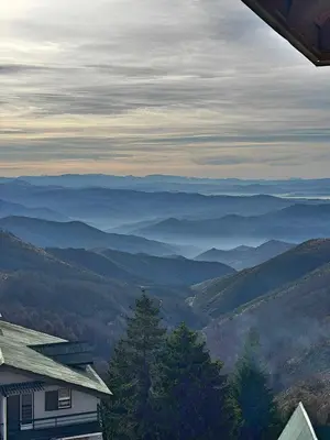 a view of a mountain valley with a house at Mujen Lux Tutic - Free Spa & Wellness in Kopaonik