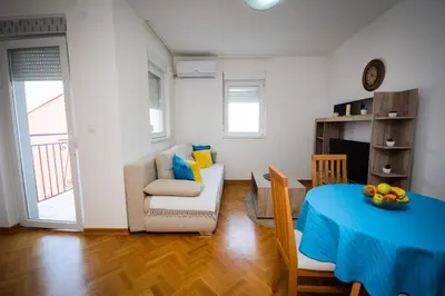 a living room with a table and a couch at Apartman Nikolina in Vrnjačka Banja