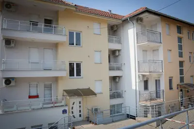 an apartment building with balconies on the side of it at Apartman Nikolina in Vrnjačka Banja