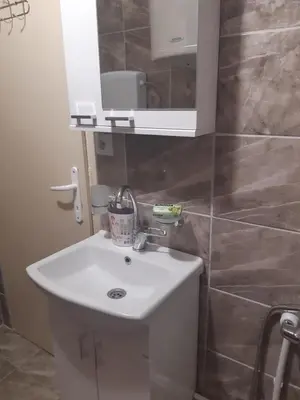 a bathroom with a white sink and a mirror at Seosko turističko domaćinstvo Stojković in Aleksinac