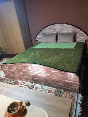 a bedroom with a bed with a brick wall at Seosko turističko domaćinstvo Stojković in Aleksinac