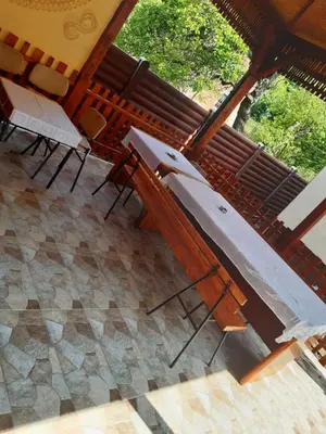 a group of chairs and an umbrella on a patio at Seosko turističko domaćinstvo Stojković in Aleksinac