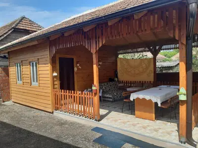 a wooden pavilion with a table and chairs on a patio at Seosko turističko domaćinstvo Stojković in Aleksinac