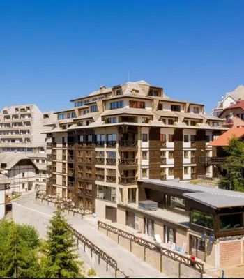 a large apartment building in a city at Apart Hotel & spa Zoned II, Kopaonik, apartman Lukač - special benifit Children up to 17 of age accompanied by two adutls staj for free! FREE PARKING! in Kopaonik