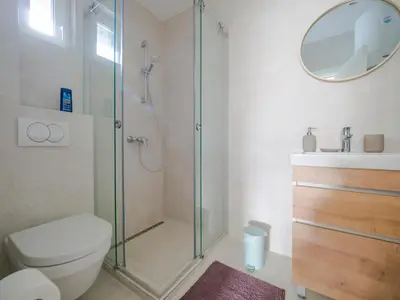 a bathroom with a shower and a toilet and a sink at Apartmani Šišarka in Kopaonik