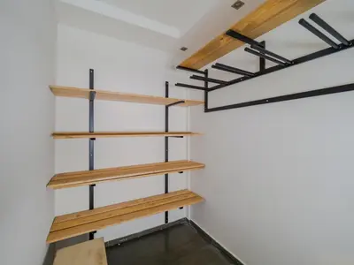 a room with wooden shelves on the wall at Apartmani Šišarka in Kopaonik