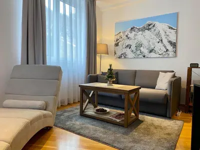a living room with a couch and a table at Ski Adventure - Brzeće, Kopaonik in Kopaonik