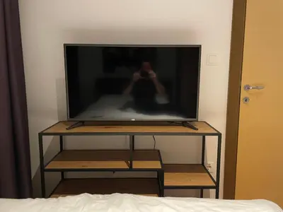 a flat screen tv on a stand in a bedroom at Ski Adventure - Brzeće, Kopaonik in Kopaonik