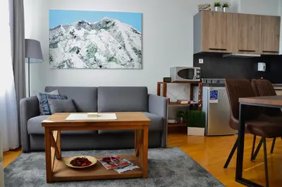 a living room with a couch and a table at Ski Adventure - Brzeće, Kopaonik in Kopaonik