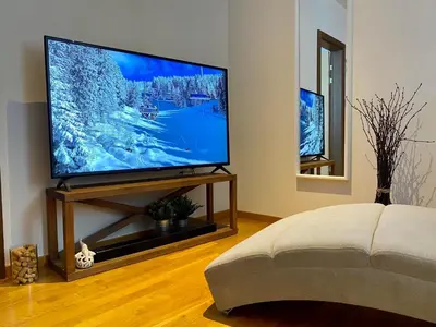 a living room with a large flat screen tv at Ski Adventure - Brzeće, Kopaonik in Kopaonik