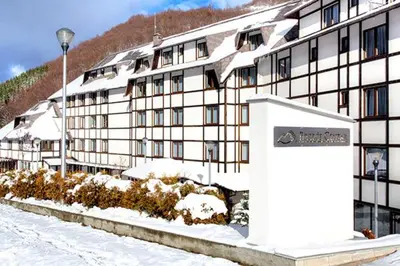 a building with a sign in front of it in the snow at Ski Adventure - Brzeće, Kopaonik in Kopaonik