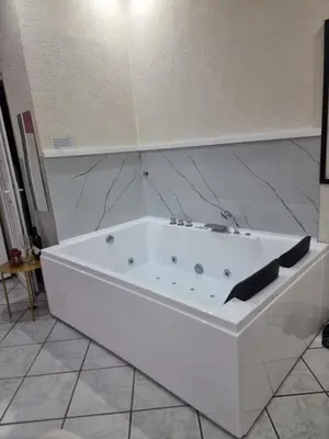 a white bath tub sitting in a bathroom at Apartman -HARMONY- in Paraćin