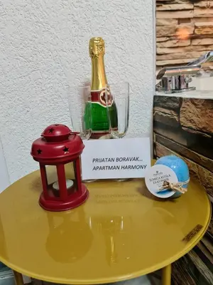 a yellow table with a bottle on top of it at Apartman -HARMONY- in Paraćin