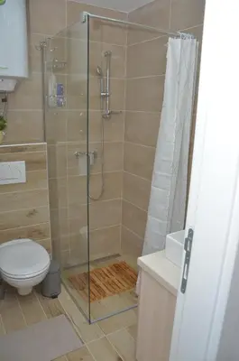 a shower with a glass door in a bathroom at Apartman Enjoy N82 Milmari&spa in Kopaonik