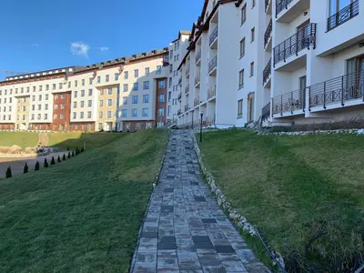 a stone path in front of a building at Apartman Enjoy N82 Milmari&spa in Kopaonik