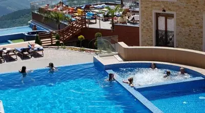 a group of people in a swimming pool at Apartman Enjoy N82 Milmari&spa in Kopaonik