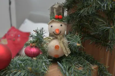 a christmas ornament of a snowman in a christmas tree at Apartman Enjoy N82 Milmari&spa in Kopaonik